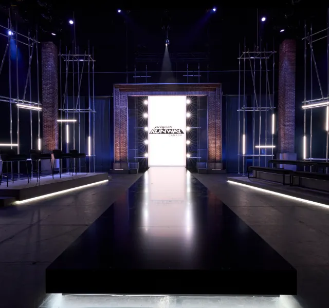 A darkened stage with scaffold towers and a glowing central screen at Chrysalis