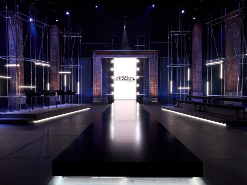 A darkened stage with scaffold towers and a glowing central screen at Chrysalis