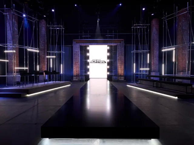 A darkened stage with scaffold towers and a glowing central screen at Chrysalis